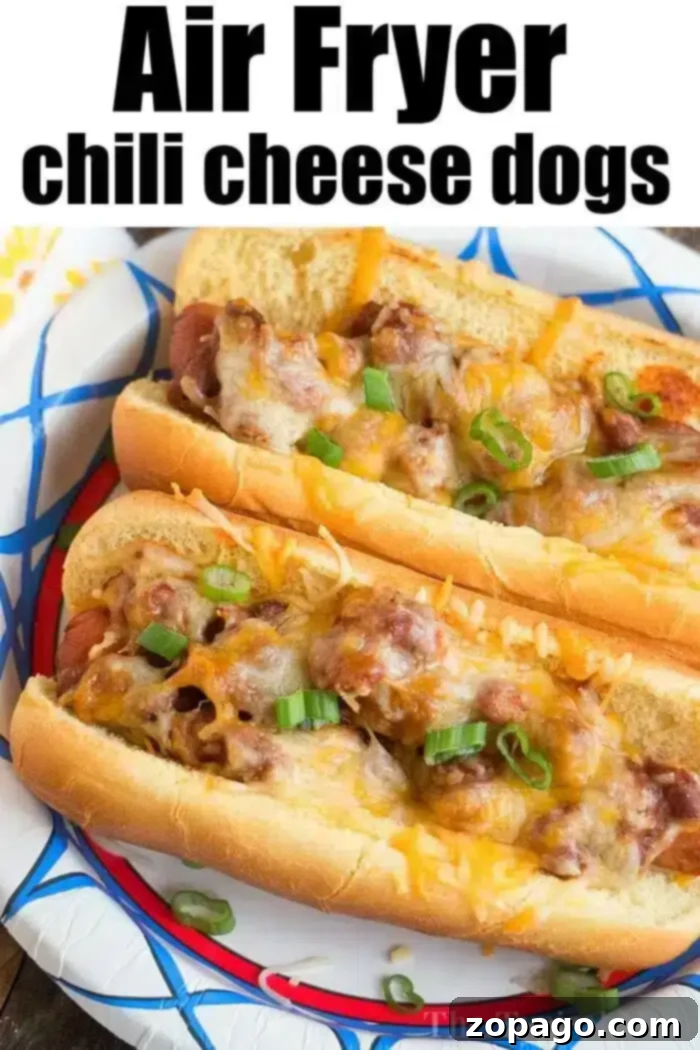 Perfectly Crispy Air Fryer Hot Dogs 10 Two chili cheese hot dogs topped with melted cheese and sliced green onions are displayed on a decorative plate. The image proudly features the text "Air Fryer Hot Dogs with Chili Cheese" at the top.