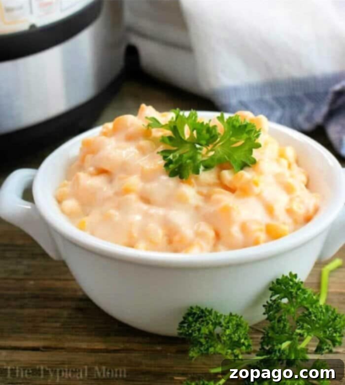 Savory Instant Pot Creamed Corn with Crispy Bacon 2 Rich and creamy Instant Pot Creamed Corn, garnished with crispy bacon bits, served in a rustic bowl on a wooden surface.