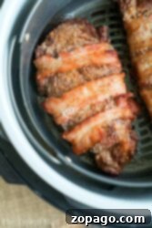Enjoy a delectable bacon-wrapped ribeye steak, cooked to perfection inside an air fryer basket, delivering the same juicy satisfaction you’d expect from a ribeye in the air fryer.
