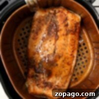 Salmon fillet, seasoned and ready for the air fryer, promising a delicious and healthy meal.