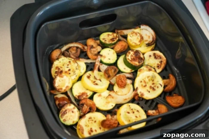 Crispy Air Fryer Veggies 6 Two distinct air fryer vegetable dishes presented side-by-side, showcasing the varied textures and vibrant colors that can be achieved through air frying, highlighting different preparation methods and ingredients.