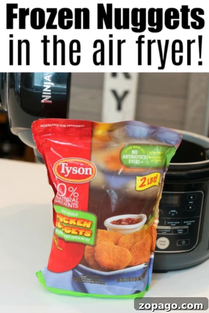 Air fryer frozen chicken nuggets in your Ninja Foodi or any other brand so they're tender inside and really crispy on the outside. This is it! #airfryer #airfryerrecipes #ninjafoodi #chickennuggets #chicken #easy #frozen Crispy frozen chicken nuggets cooked to golden perfection in an air fryer.