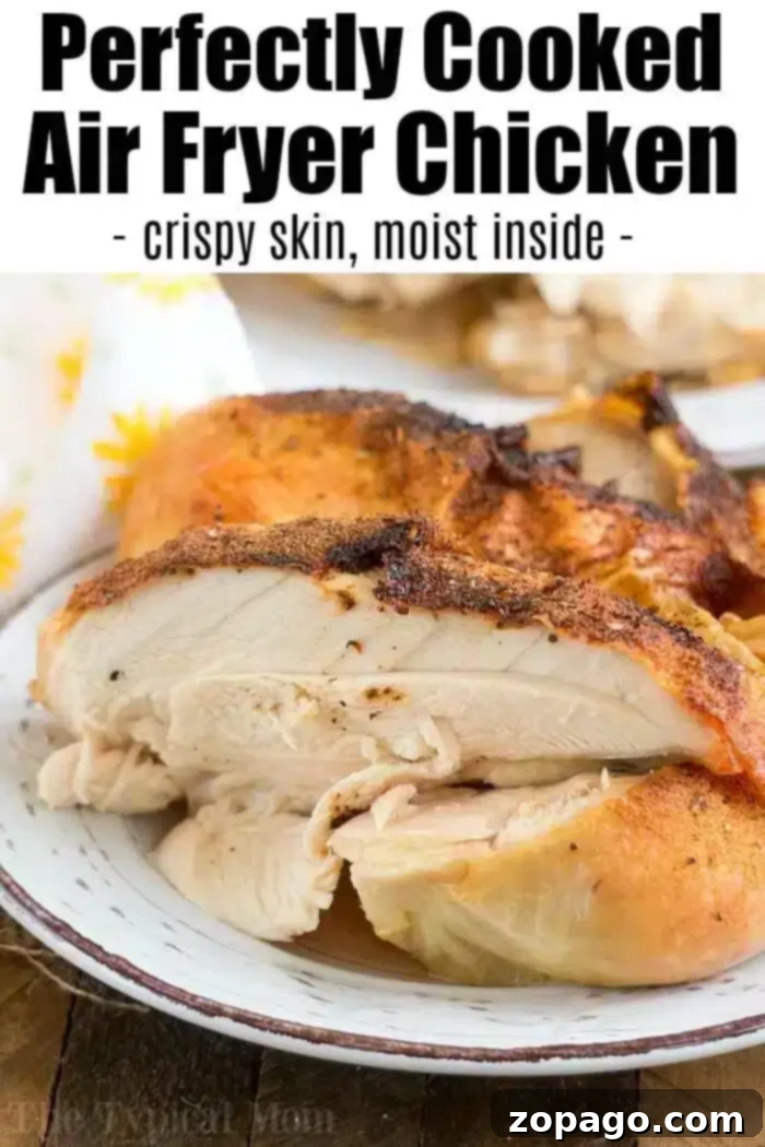 A serving of perfectly cooked air fryer whole chicken on a plate, featuring crispy, golden skin and moist, tender interior. The text overlay reads, 'Perfectly Cooked Air Fryer Chicken - crispy skin, moist inside.'