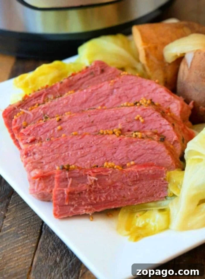 Ninja Foodi Corned Beef and Cabbage Perfection 2 Perfectly cooked Ninja Foodi corned beef, sliced and ready to serve with steamed cabbage and potatoes, a vibrant and comforting dish.