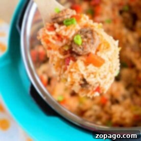 A wooden spoon scoops pressure cooker jambalaya from an Instant Pot, garnished with sliced green onions.