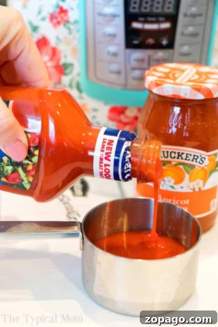 Apricot Glazed Pressure Cooker Chicken 5 Ingredients for Instant Pot Apricot Chicken: a hand pouring Catalina salad dressing into a measuring cup, with a jar of apricot preserves in the background.