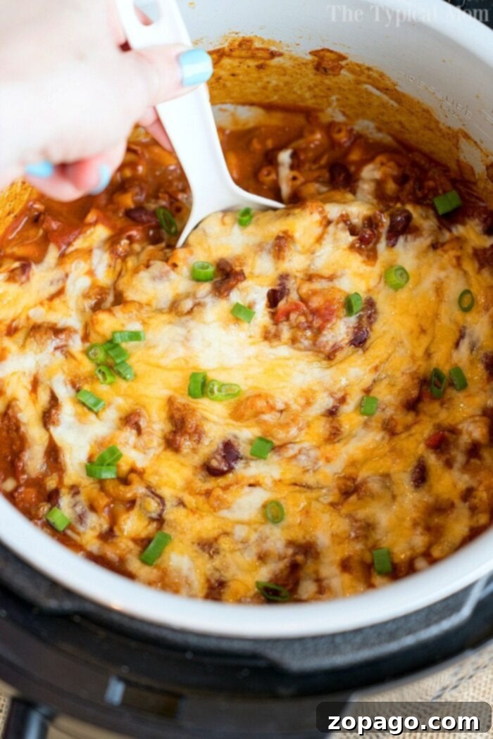 Quick and Easy Instant Pot Meals for Kids 7 A close-up of a delicious pressure cooker cheesy chili mac, rich with pasta, meat, and melted cheese, ready to be served.
