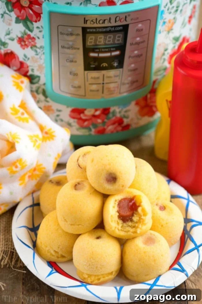 Instant Pot corn dog bites are easy to make in your Instant Pot, Crock Pot Express or Ninja Foodi! The perfect snack or lunch your kids will love. #instantpotrecipes #instantpot #ninjafoodi #ninjafoodirecipes #corndogs #eggmold #pressurecooker #snacks #lunch #corndogbites Delicious and easy Instant Pot corn dog bites, served hot and ready to enjoy.
