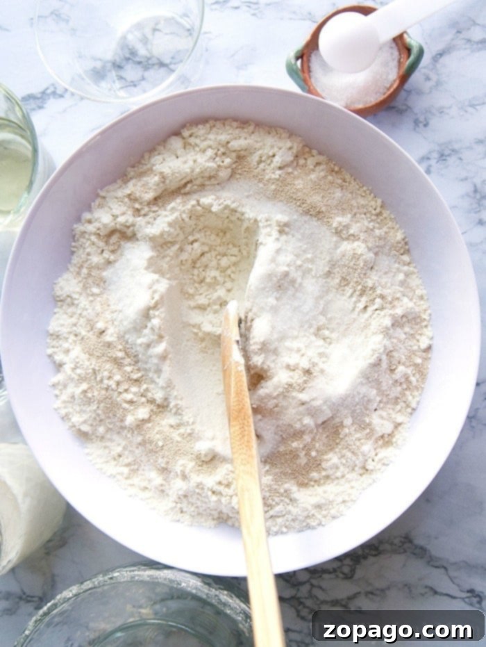 Fluffy homemade dinner rolls for any meal. A batch of warm, freshly baked dinner rolls in a round pan, ready to be served.
