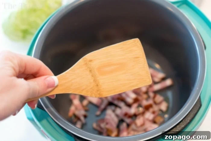 Easy Instant Pot Cabbage and Noodles, a quick and delicious meal. A close-up of a bowl filled with comforting Instant Pot cabbage and noodles, featuring tender pasta and savory bacon pieces. This easy one-pot meal is ready to serve, showcasing its appealing textures and colors.