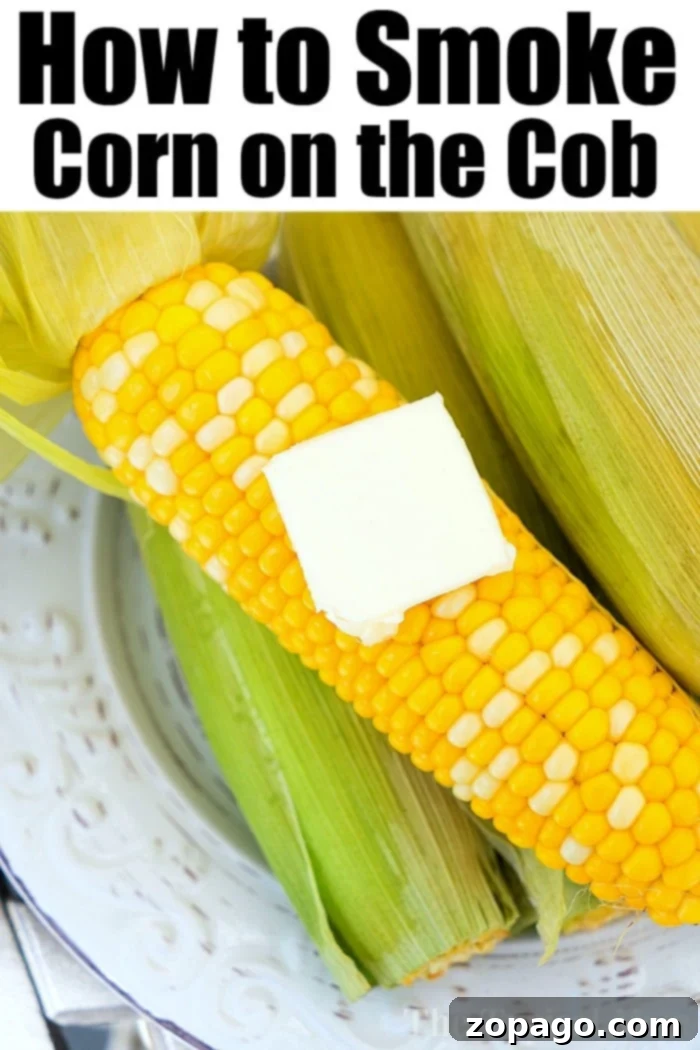 Hands holding smoked corn on the cob, ready to eat.