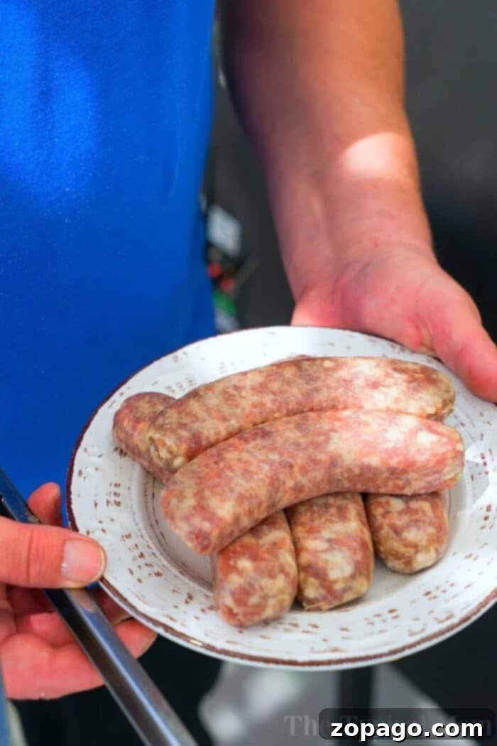 Smoked brats are a delicious lunch or dinner idea you can make in your pellet or electric smoker this week! If you haven't smoked sausage yet, try this! #smokerrecipes #smoked #smoker #sausage #brats #traeger Smoked brats on a smoker rack with beautiful char marks