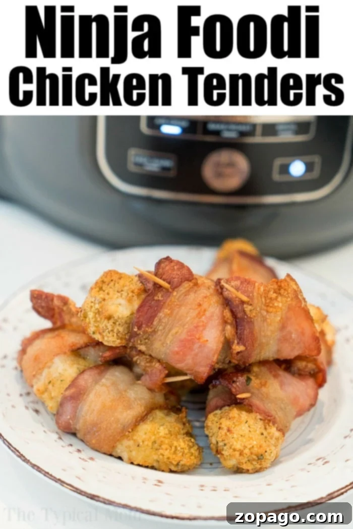 Ninja Foodi chicken tenders wrapped in bacon are here for you to enjoy tonight! Easy 20 minute air fryer dinner idea even the kids will love. #airfryerrecipes #airfryer #ninjafoodi #chickentenders #chicken #homemade #chickenstrips #thetypicalmom #bacon Platter of Ninja Foodi chicken tenders, some bacon-wrapped, ready to serve
