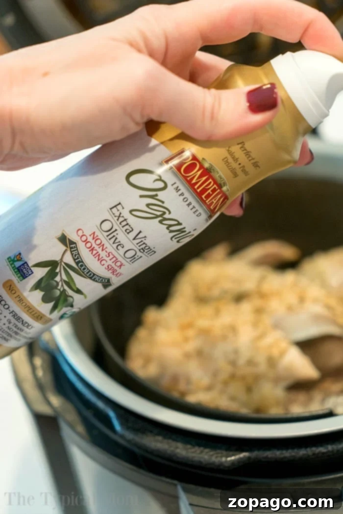 Ninja Foodi chicken recipe, emphasizing the tender meat from the pressure cooking phase. #ninjafoodi #ninjafoodirecipes #pressurecooker #airfryer #chicken #wholechicken #keto #thetypicalmom Whole chicken cooked in a pressure cooker, showcasing its juicy, tender interior before crisping.