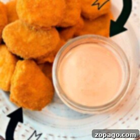Chicken nuggets next to a small bowl of fry sauce on a white plate. Perfect for those wondering how to make that ultimate dipping delight!