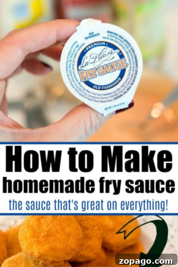 A close-up of a small dish of fry sauce with a spoon, highlighting its smooth, creamy texture.