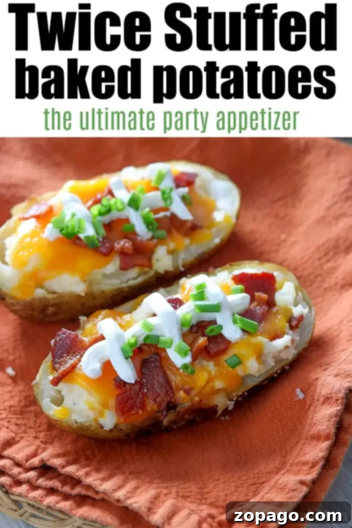 Delicious Make Ahead Twice Stuffed Potatoes: The ultimate party appetizer for oven or air fryer! Two exquisitely prepared make-ahead twice-stuffed baked potatoes sit invitingly on an orange cloth. Each potato is lavishly topped with rich melted cheese, savory bacon, a dollop of cool sour cream, and a generous sprinkle of vibrant chopped green onions, making them the ultimate party appetizer.