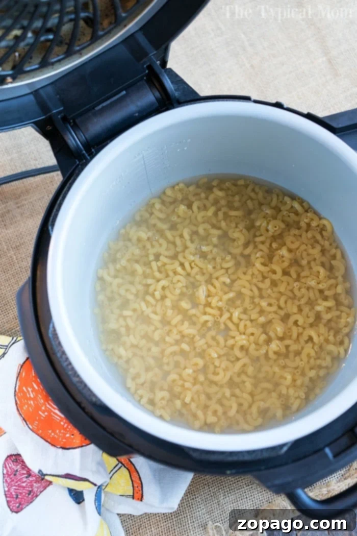 Ninja Foodi mac and cheese - quick, easy, and delicious. Pressure cooker macaroni and cheese made in a Ninja Foodi