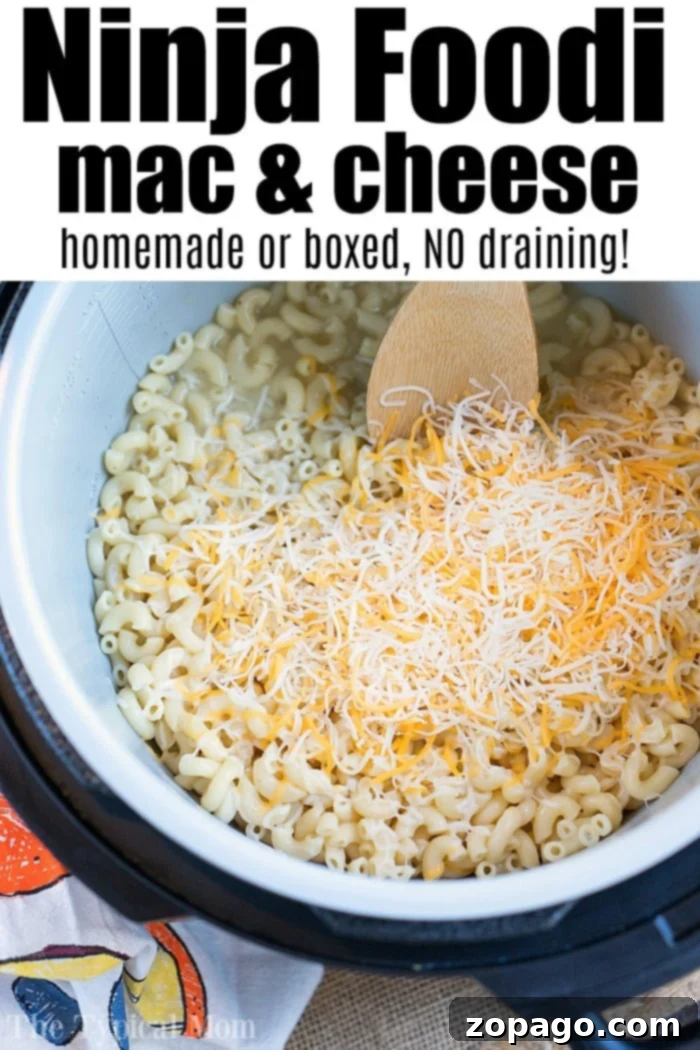 EASY Ninja Foodi macaroni and cheese recipe that is the BEST pressure cooker mac and cheese you'll ever make in under 15 minutes flat! Cheesy perfection. Ninja Foodi macaroni and cheese recipe, showcasing its irresistible cheesy texture.