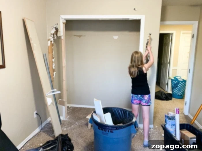 Creating Your Dream Dressing Room 4 Demolition phase of a bedroom conversion, showing exposed walls and the framework for a new closet entrance.