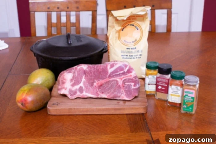 A tender pork roast, perfectly cooked, resting inside a traditional black Dutch oven, ready to be shredded or sliced for serving.