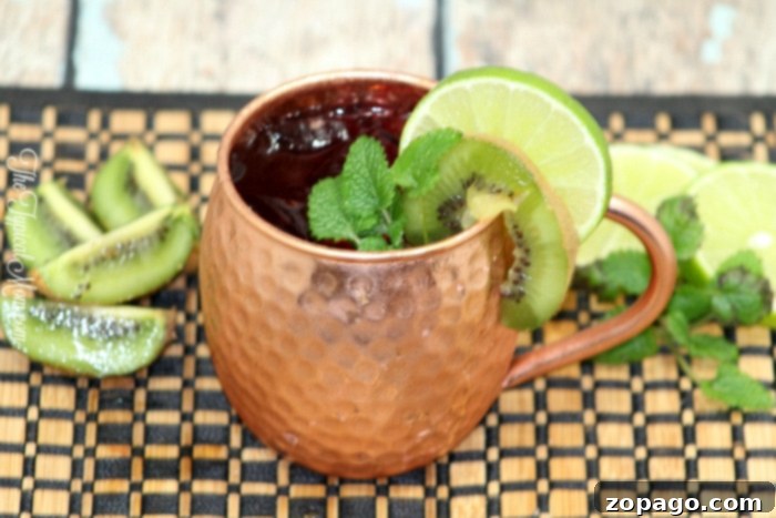 Beat the Heat: 10 Must-Try Summer Cocktails 7 A copper mug filled with a Moscow Mule, garnished with lime and mint, evoking classic cocktail enjoyment