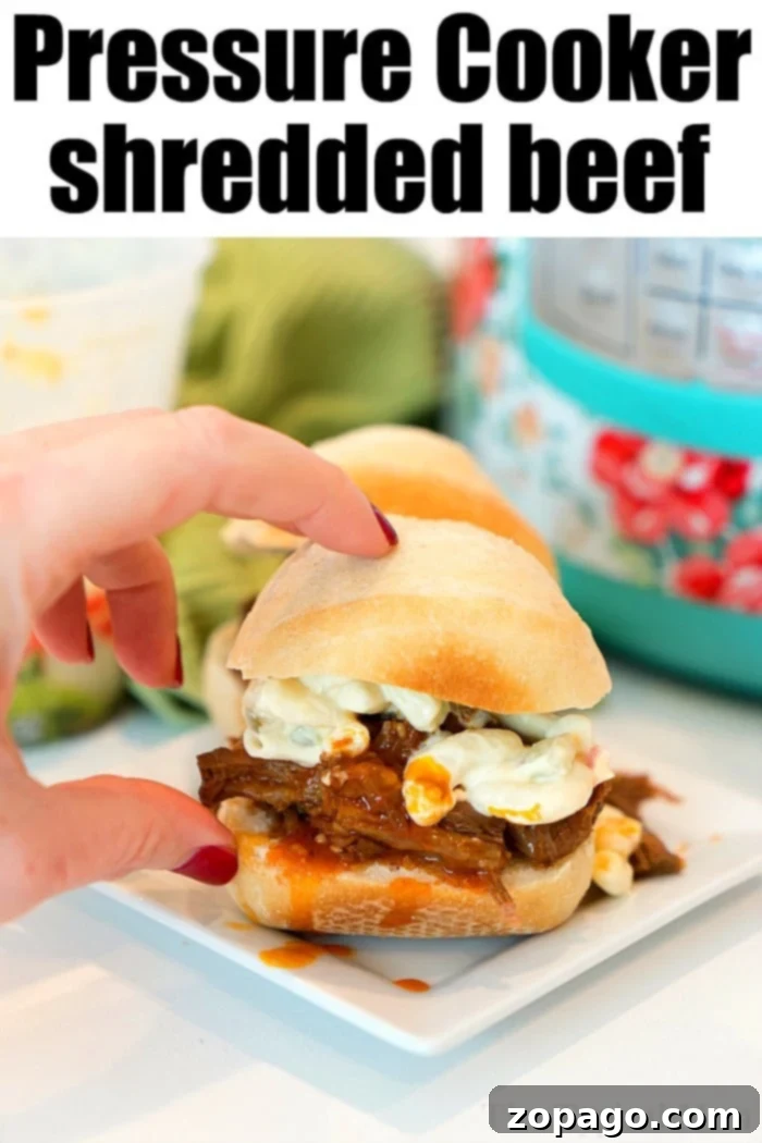 Instant Pot pulled beef for dinner tonight! Tender meat stacked on rolls to make sliders = a great appetizer or dinner for your family. Pressure cooker shredded beef, prepared for a family meal.