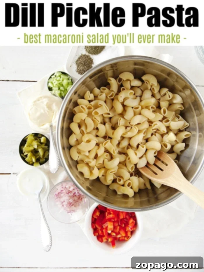 Zesty Dill Pickle Pasta Salad Without Sour Cream 3 Close-up of vibrant dill pickle pasta salad in a white bowl, showcasing ingredients.
