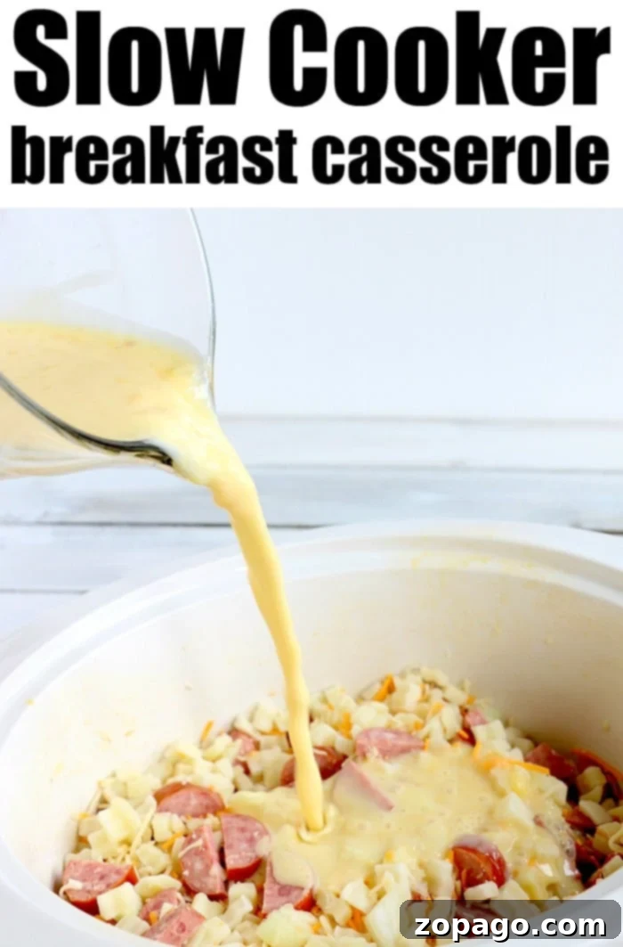 Effortless Slow Cooker Cheesy Hashbrown Bake 6 A full slow cooker brimming with golden-brown, cheesy breakfast potatoes and savory sausage, ready to be served for a comforting morning meal.