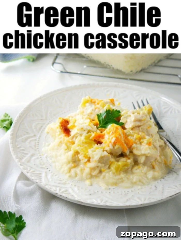 Rice green chile chicken casserole is so good! With hatch chiles and cream cheese inside topped with cheddar cheese it's sure to be a great dinner. #greenchile #casserole #rice #chicken #creamcheese Green Chile Chicken Casserole