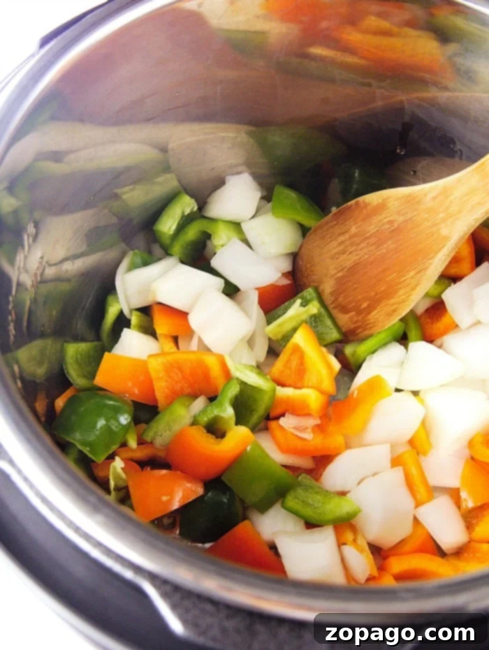 Sweet and sour chicken made with frozen popcorn chicken is the easiest meal ever that everyone loves! Panda Express copycat recipe for sure. #instantpot #chicken #sweetandsourchicken #pressurecooker #easy #thetypicalmom the typical mom instant pot recipes