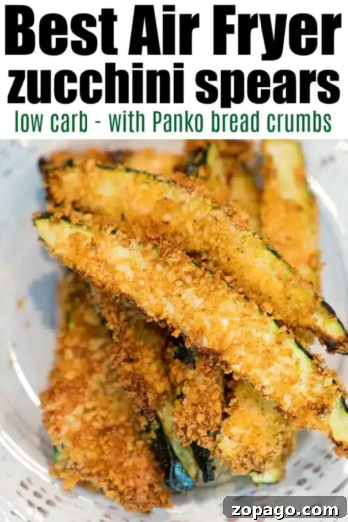 Air fryer zucchini fries are a great side dish or a healthy low carb snack your whole family will love! It's our favorite vegetable air fryer recipe. #airfryer #airfryerrecipes #zucchini #fries #zucchinifries #spears #lowcarb A bowl of golden-brown zucchini spears coated in Panko bread crumbs, labeled "Best Air Fryer zucchini fries low carb - with Panko bread crumbs." The spears are arranged in a pile, showcasing their crispy texture and appealing golden color.