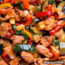 Delight in this air fryer fajitas featuring juicy chicken strips, vibrant red and yellow bell peppers, and crisp zucchini slices for a quick fajitas twist.