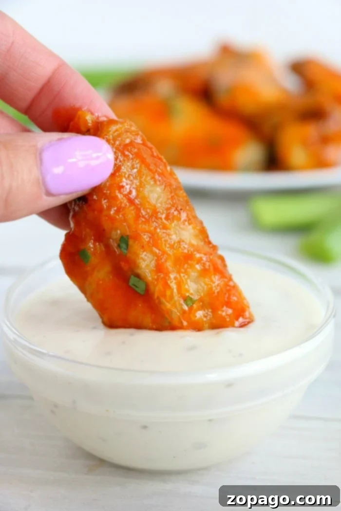 Frozen chicken wings in air fryer machines actually turn out great! Tender meat on the inside with a crispy skin and smothered in sauce. It's the way to go! #frozen #wings #chickenwings #airfryer #airfryerrecipes #frozenwings air fryer wings
