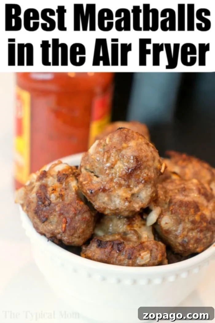 Easy Air Fryer Meatballs 7 Close-up of crispy meatballs in the air fryer basket, ready to be removed.