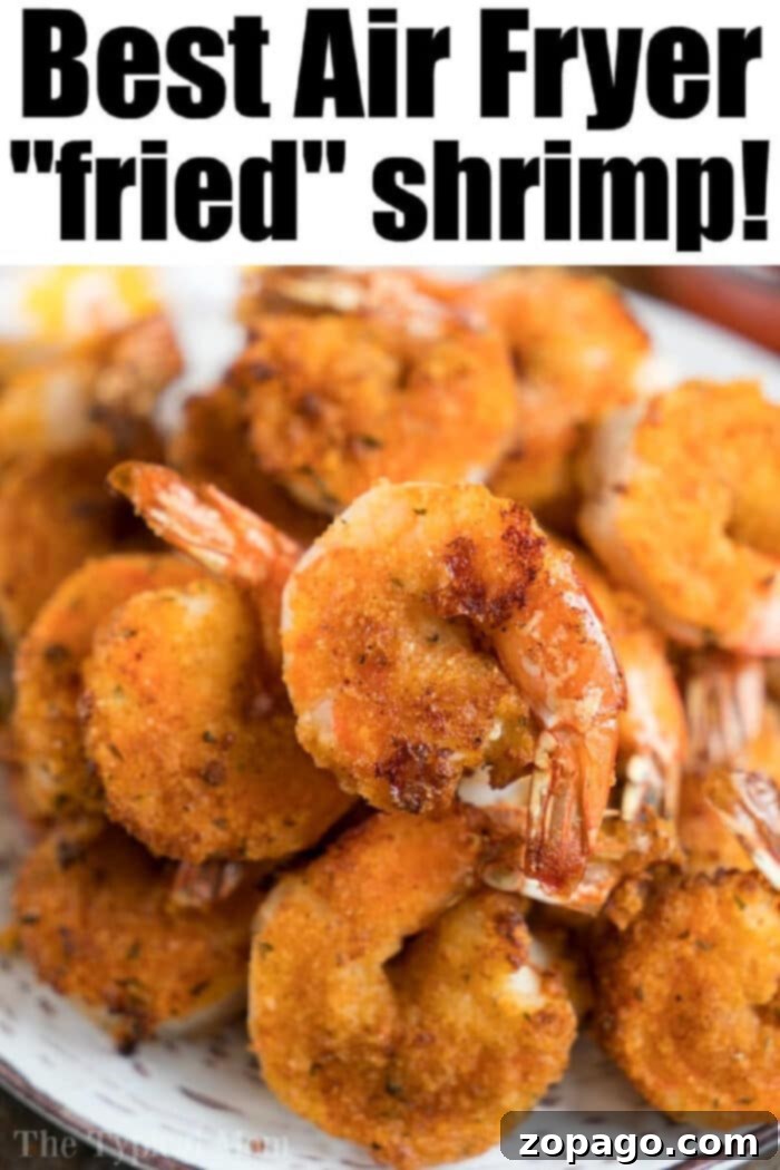 This air fryer fried shrimp recipe is amazing! With a light breading & tons of flavor they're crispy to perfection in just a few minutes with NO frying required. A beautifully plated dish of crispy, golden-brown air fryer fried shrimp, perfectly breaded and cooked to perfection, ready to be served.