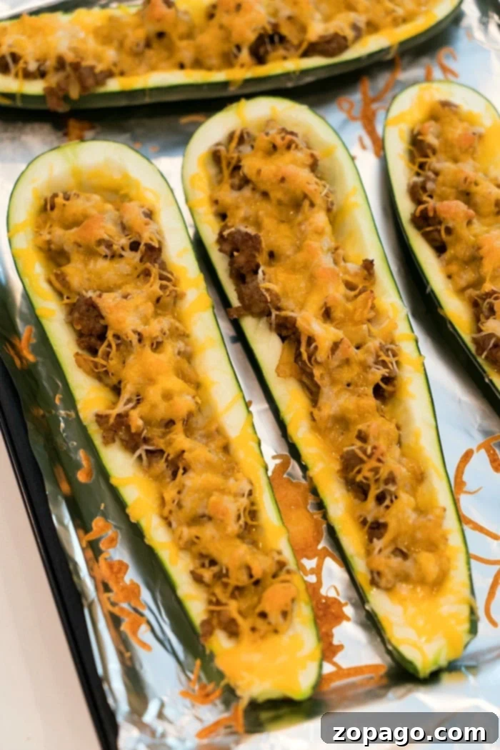 Taco-Filled Zucchini Boats 6 Step-by-step guide on how to make zucchini taco boats, showing the scooping and filling process.