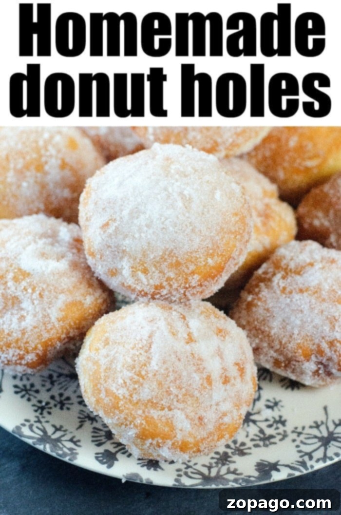 Homemade donut holes are puffy and sweet. The perfect sweet treat for breakfast or dessert at your home this week. They're easier to make than you think. #donuts #doughnuts #homemade #donutholes #fried #breakfast A generous serving of homemade donut holes covered in powdered sugar, ready for sharing.