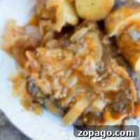 A close-up of a serving of Instant Pot steak, potatoes, and gravy.