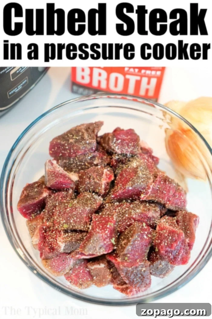 Savory Instant Pot Beef Tips 4 A bowl of seasoned raw steak sits next to beef broth and a sliced onion, with an Instant Pot visible in the background, ready for making delicious beef tips and gravy.