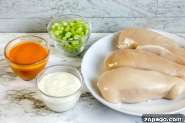 Slow Cooker Buffalo Chicken Sliders 3 Slow cooker buffalo chicken simmering to perfection
