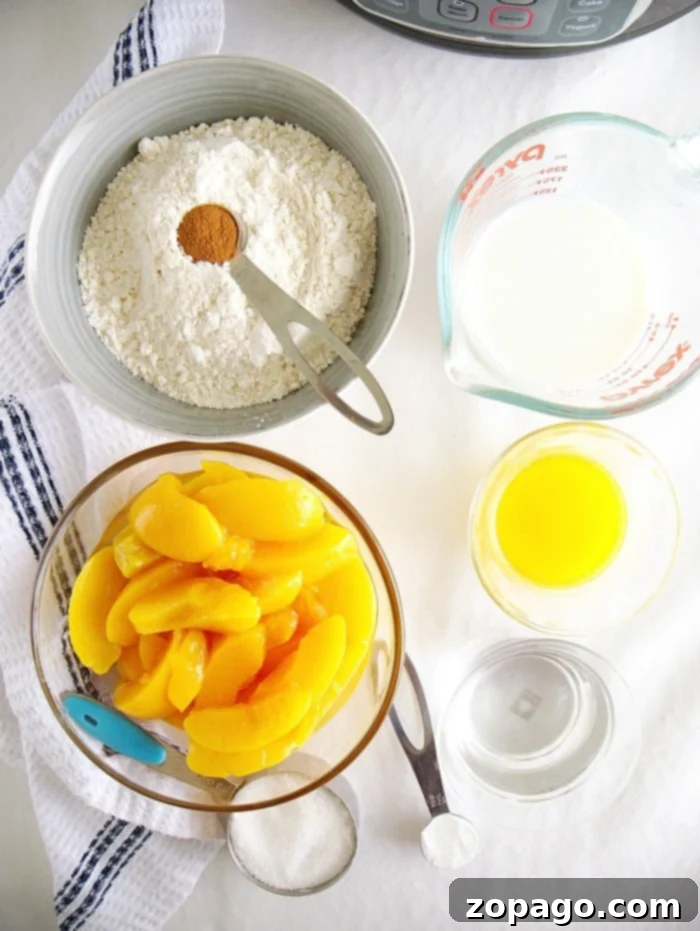 Easy Instant Pot Peach Cobbler 3 Close-up of a warm, golden-brown peach cobbler with a crumbly topping, served in a bowl with a spoon.