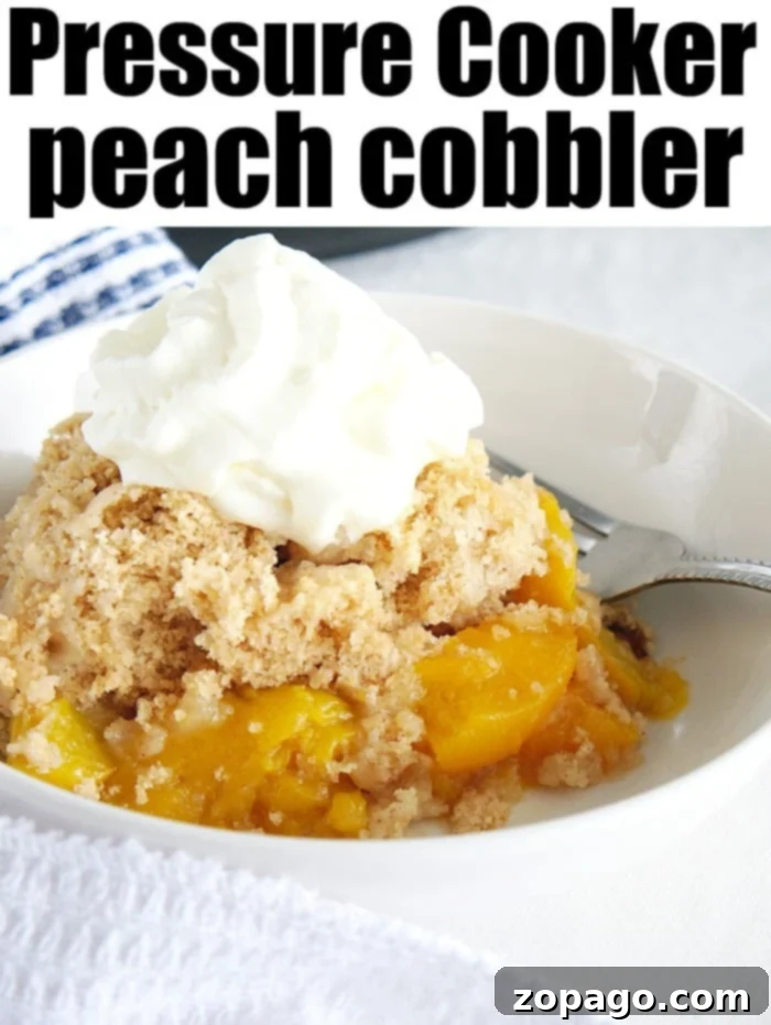 Easy Instant Pot Peach Cobbler 6 A bowl of freshly made Instant Pot peach cobbler, topped with a dollop of whipped cream, ready to be enjoyed.