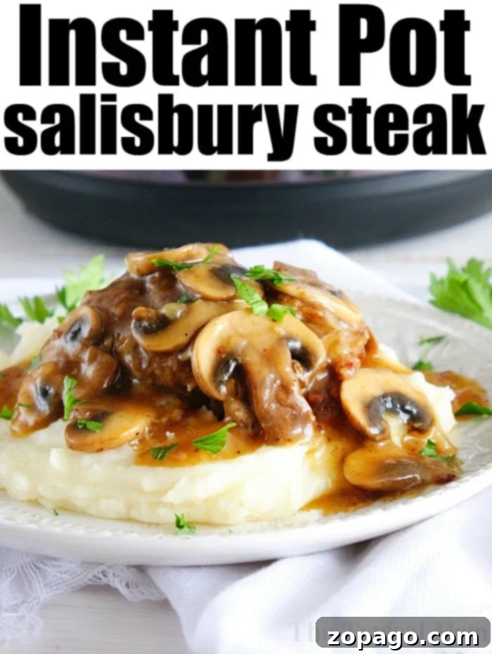 Best Instant Pot Salisbury Steak: Tender patties in a flavorful mushroom gravy, perfect for any family meal. Instant Pot Salisbury steak served with a rich mushroom gravy, mashed potatoes, and a green vegetable.