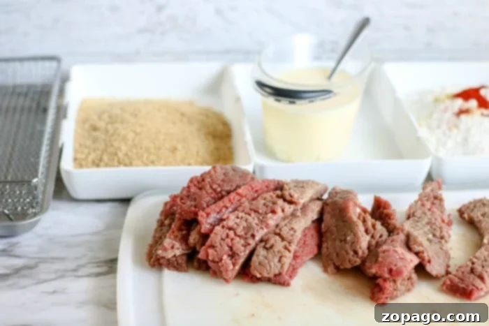 Air Fryer Chicken Fried Steak: Crispy, Guilt-Free Comfort 6 Air Fried Country Fried Steak - A close-up shot of golden, crispy air-fried country fried steak fingers.