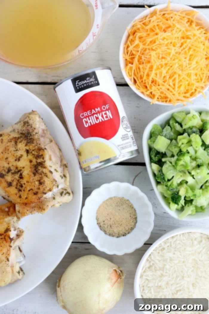 Crockpot chicken and rice casserole is a family favorite! Tender chicken thighs, broccoli and perfectly cooked rice smothered with cheese of course. #crockpot #slowcooker #chickenandrice #chickenthighs #chicken #rice Close-up of a serving of cheesy chicken and rice casserole from the crockpot, highlighting the tender chicken, fluffy rice, and melted cheese.