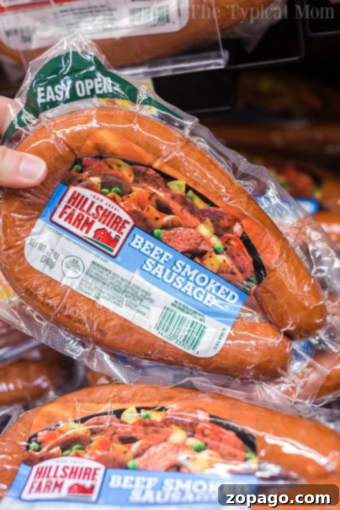 Sausage and rice casserole is so good! A cheesy casserole packed with smoked sausage, tender rice and vegetables cooked all in one pot in no time at all. #instantpot #instantpotrecipes #sausage #rice #casserole #cheesy #pressurecooker #ninjafoodi Package of Hillshire Farm beef smoked sausage displayed in a store aisle, perfect for a quick and tasty meal.