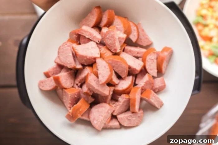 Hearty Cheesy Instant Pot Sausage and Rice 3 A close-up of savory Instant Pot sausage and rice, ready to be served from a pressure cooker.