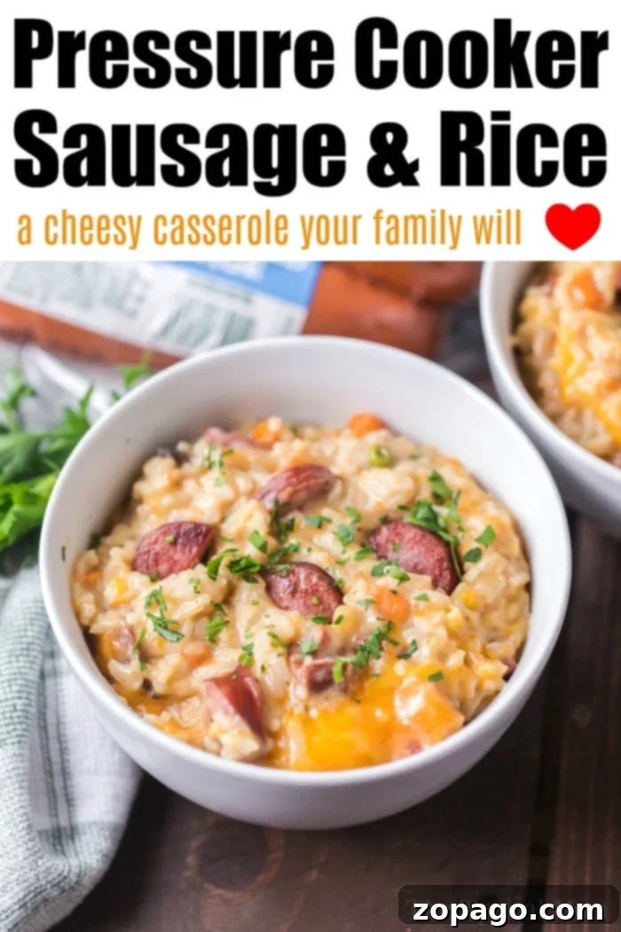 Instant Pot sausage and rice is so good! A cheesy casserole packed with smoked sausage, tender rice and vegetables cooked all in one pot in no time at all. #instantpot #instantpotrecipes #sausage #rice #casserole #cheesy #pressurecooker #ninjafoodi A hearty serving of Instant Pot sausage and rice, showcasing tender grains and succulent sausage.
