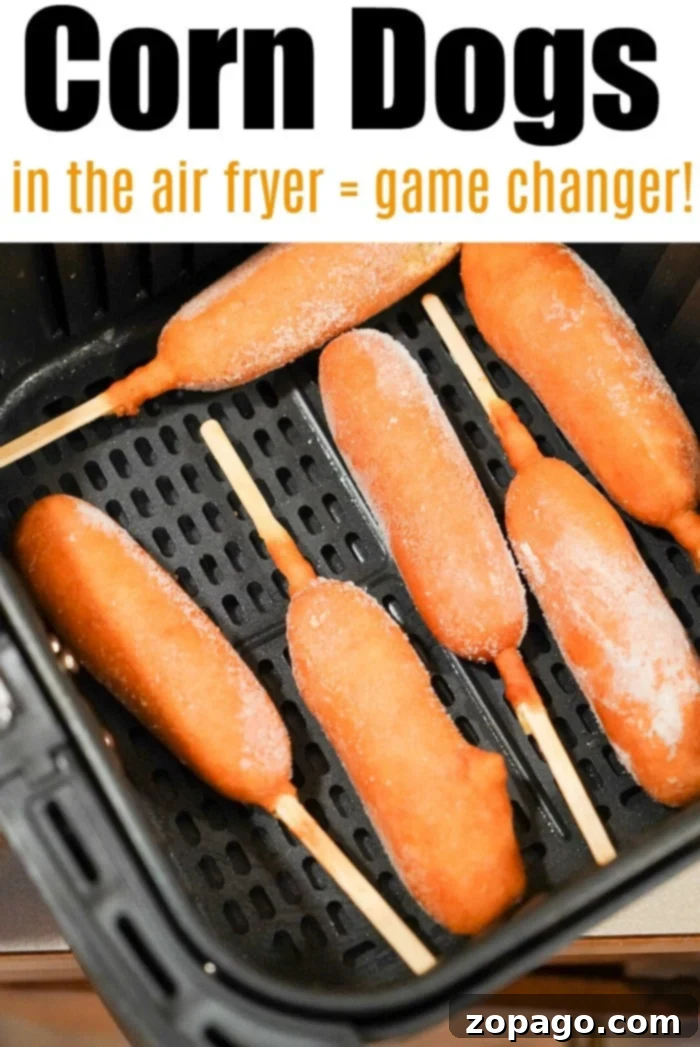 Various frozen foods like corn dogs, chicken nuggets, and tater tots cooked to perfection in an air fryer, laid out on a tray.